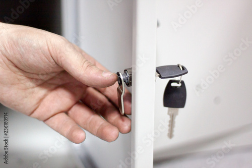 A worker came to the office to check and repair the lockers. the process of replacing the installation of parts locks. metal locker storage. selective focus. 