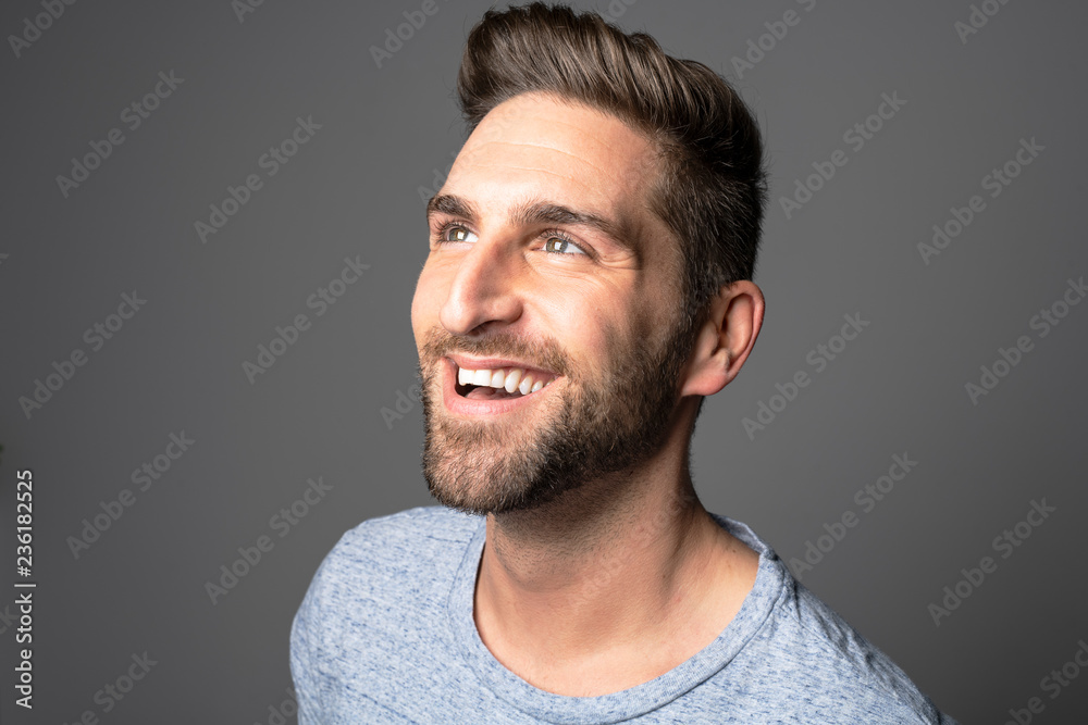 A Handsome man standing over dark grey background Portrait man concept. A Handsome man standing over dark grey background Portrait man concept.