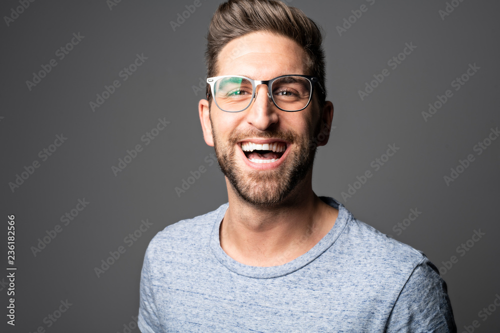 A Handsome man standing over dark grey background Portrait man concept. A Handsome man standing over dark grey background Portrait man concept.