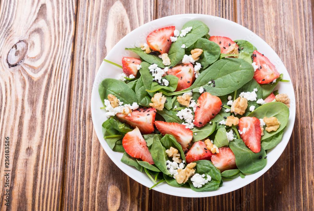 Strawberry salad with spinach , cheese and walnut . Healthy food Strawberry salad with spinach , cheese and walnut . Healthy food