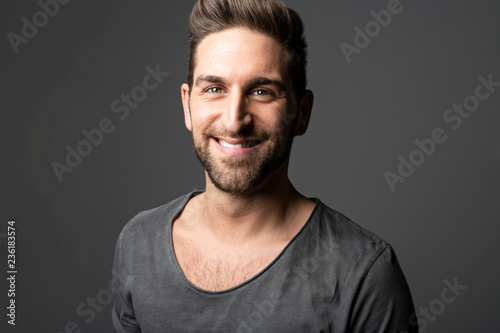 A Handsome man standing over dark grey background Portrait man concept.