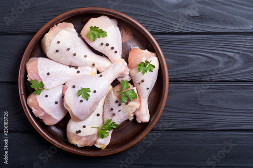 Raw chicken legs with spices and parsley. Food background