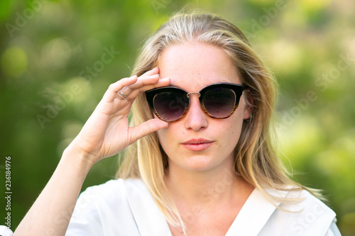 Confident woman with sunglasses looking at camera