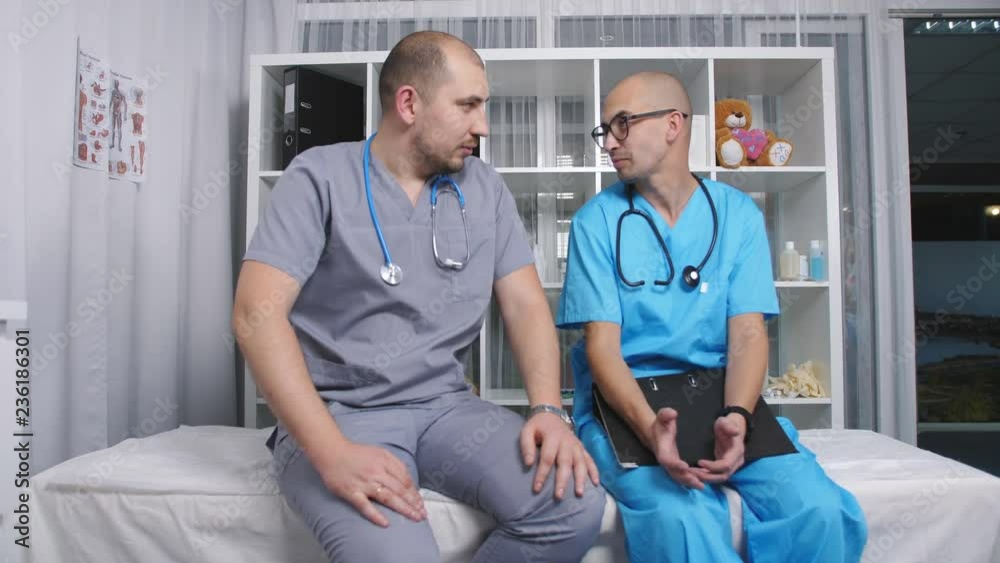 Two men relax and talk in the staff room of the clinic. Two men relax and talk in the staff room of the clinic.