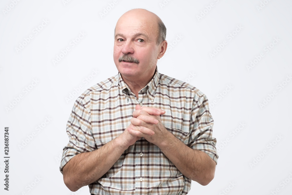 Lack of confidence. Shy senior man feels awkward. He is afraid to ask for a favor. Lack of confidence. Shy senior man feels awkward. He is afraid to ask for a favor.