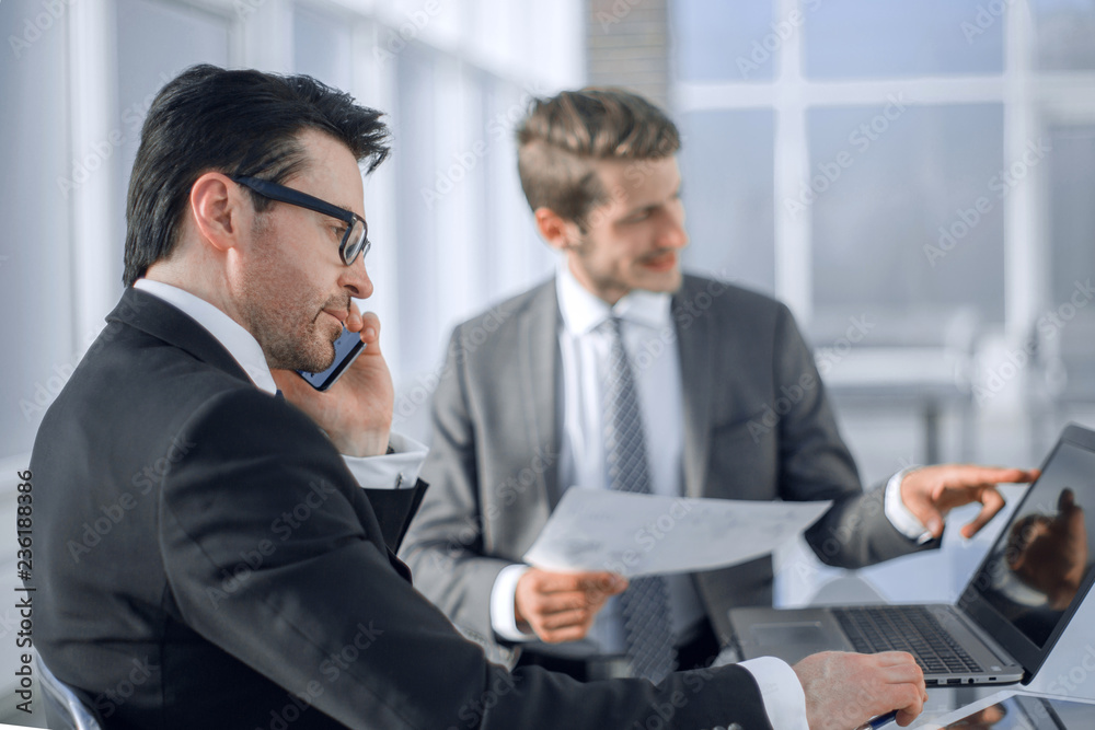 employees use a laptop to check new data. employees use a laptop to check new data.
