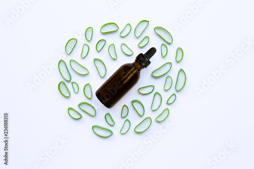 Top view. Bottle of essential oil with aloe vera on white