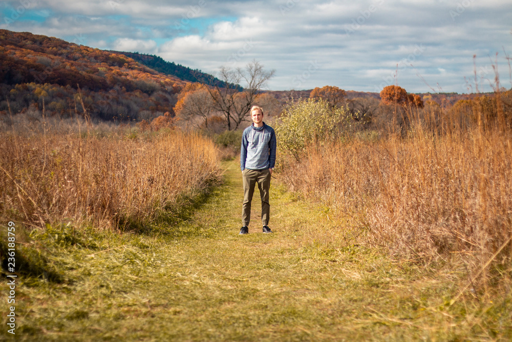 Man standing in a fall field
