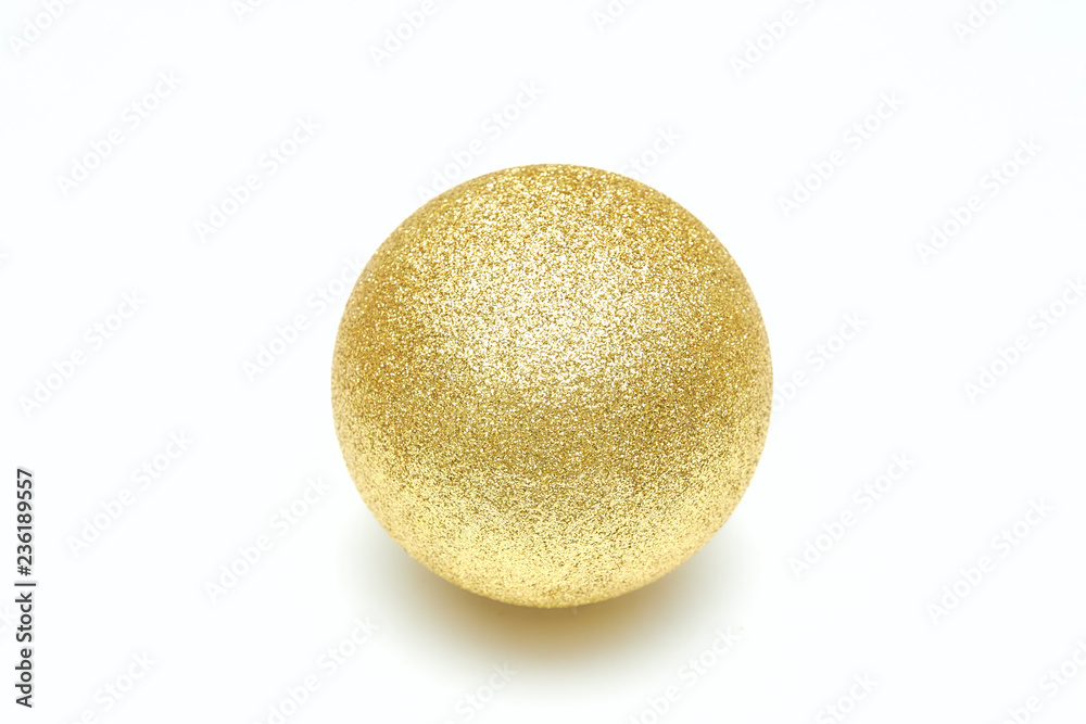 Golden shiny christmas ball isolated on a white background. Decorative toy. Golden shiny christmas ball isolated on a white background. Decorative toy.