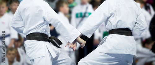 karate do kids fight on blur background. Sport competition photo