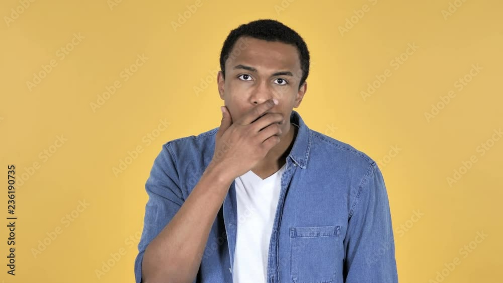 Surprised Young African Man in Shock Isolated on Yellow Background, wondering Surprised Young African Man in Shock Isolated on Yellow Background, wondering