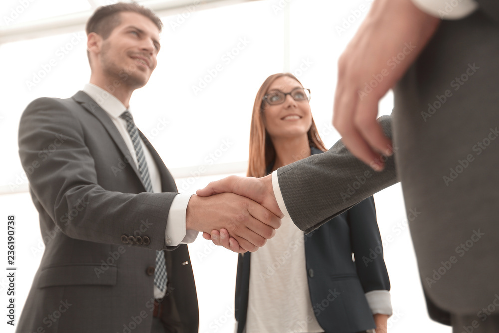 Business shaking hands in the office Business shaking hands in the office