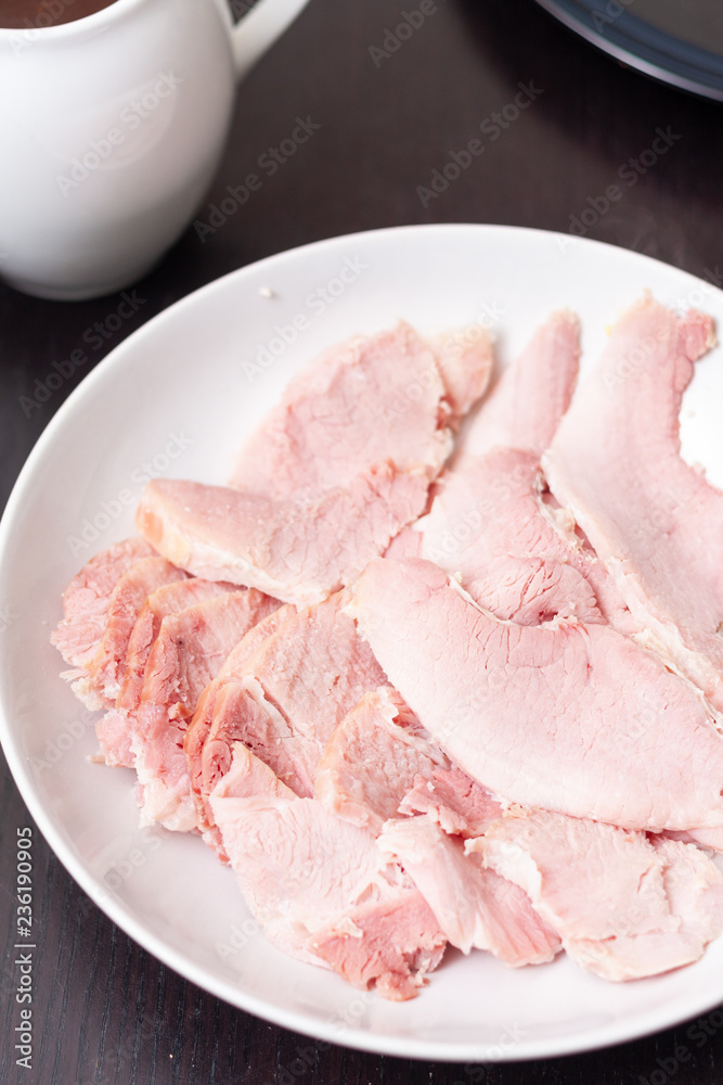 A plate with slices of boiled ham A plate with slices of boiled ham