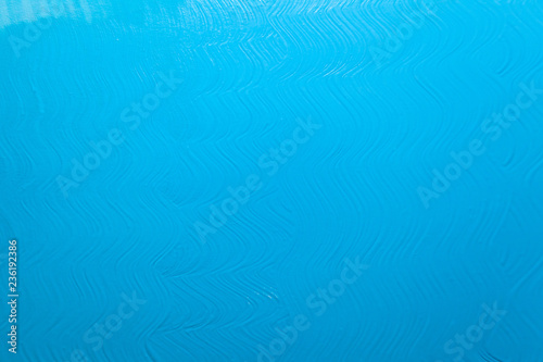 bright blue surface with paint strokes, background, texture © Sergey
