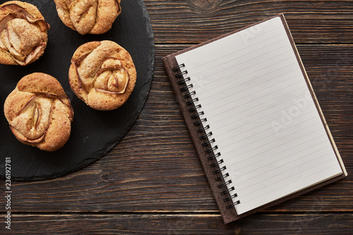 notebook, muffins on black plate photo