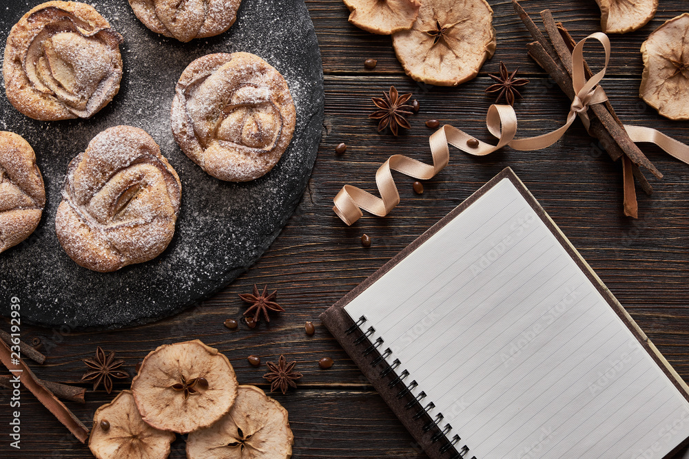 Fototapeta premium notebook, muffins on black plate