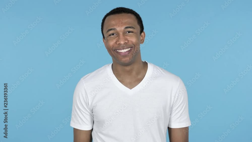 African Man Waving Hand to Welcome Isolated on Blue Background African Man Waving Hand to Welcome Isolated on Blue Background