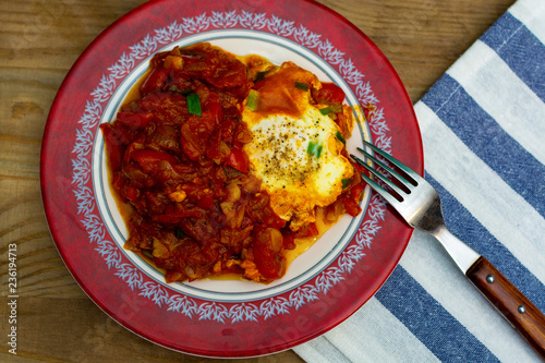 eggs in tomato sauce in a plate - Shakshuka photo