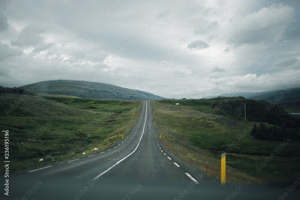 View from inside car or van on empty hilly road leading to horizon line, endless travelling roadtrip destination. Explore iceland during winter on white nights. Cloudy, rainy and moody day View from inside car or van on empty hilly road leading to horizon line, endless travelling roadtrip destination. Explore iceland during winter on white nights. Cloudy, rainy and moody day