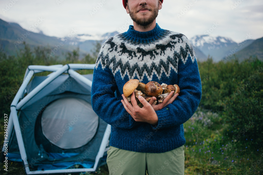 Happy proud picker man in traditional blue wool sweater with