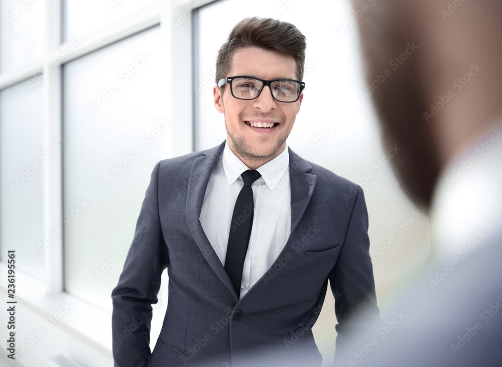 young employee standing in the office. young employee standing in the office.