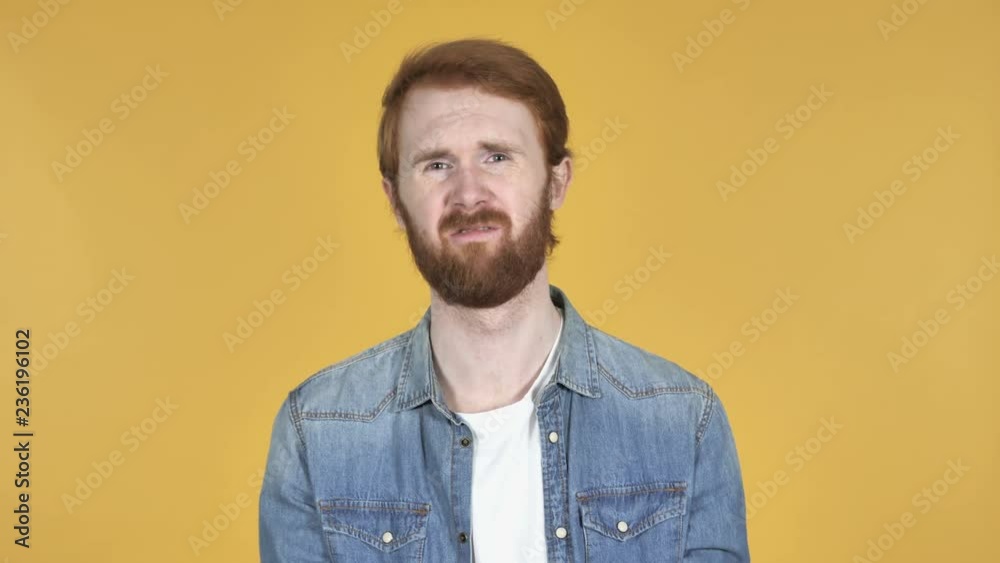 Unhappy Redhead Man Reacting to Failure and Problems Isolated on Yellow Background Unhappy Redhead Man Reacting to Failure and Problems Isolated on Yellow Background