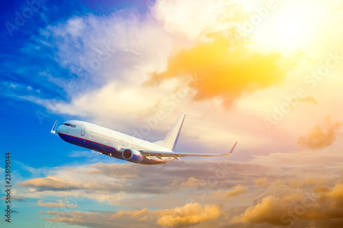 Airplane take off on the blue sky, big jet plane flying on blue cloudy sky background,idyllic sunlight on cloud fluffy