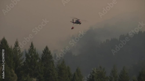 Military helicopter being used to fight forest fires in California photo