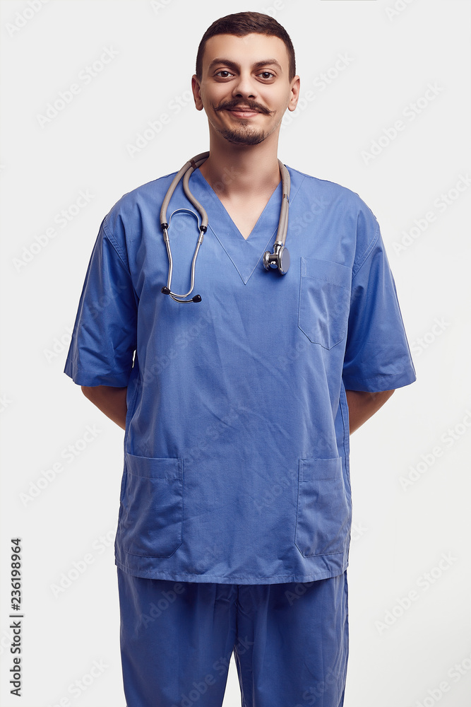 Handsome young arabic doctor with fancy mustache in blue Handsome young arabic doctor with fancy mustache in blue