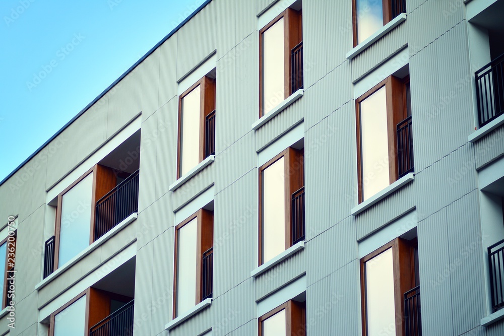 Modern apartment buildings on a sunny day with a blue sky. Facade of a modern apartment building