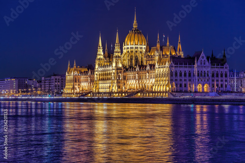 Parliament building of Budapest above Danube river in Hungary at night.