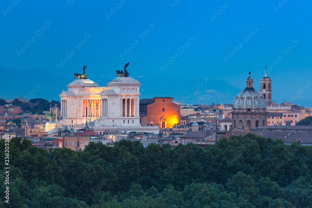Aerial wonderful view of Rome with Altar of the Fatherland and churches at night in Rome, Italy