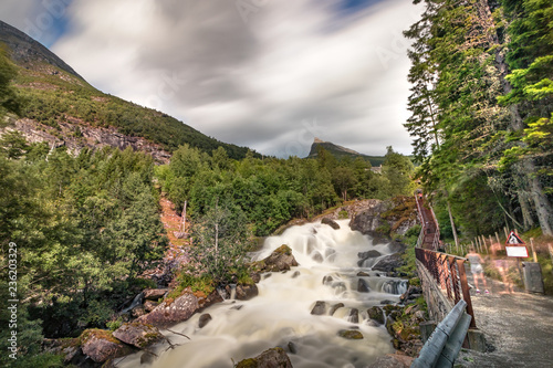 View of the river Geirangerelvi and the waterfall Storfossen in Geiranger, Norway. photo