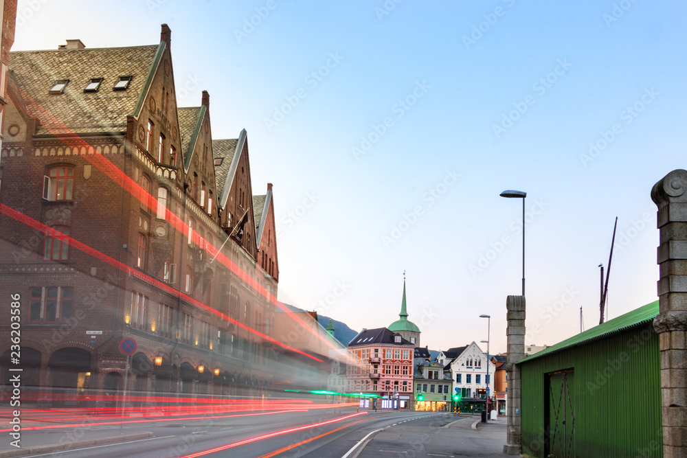 An street of Bergen center with light tiles from buses at evening, Norway.