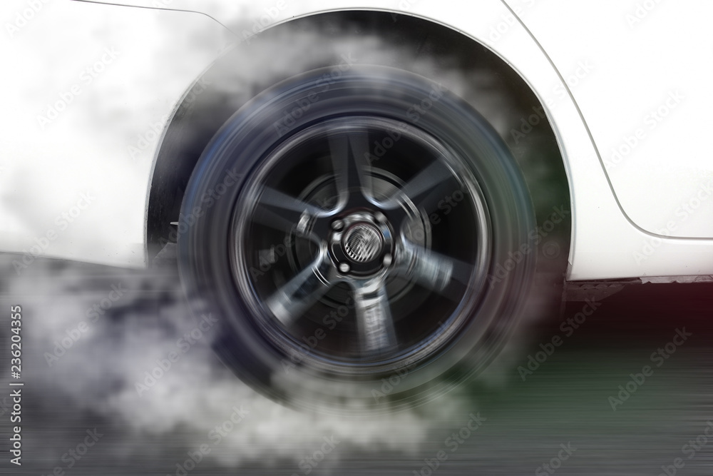 White car wheel drifting and smoking on track