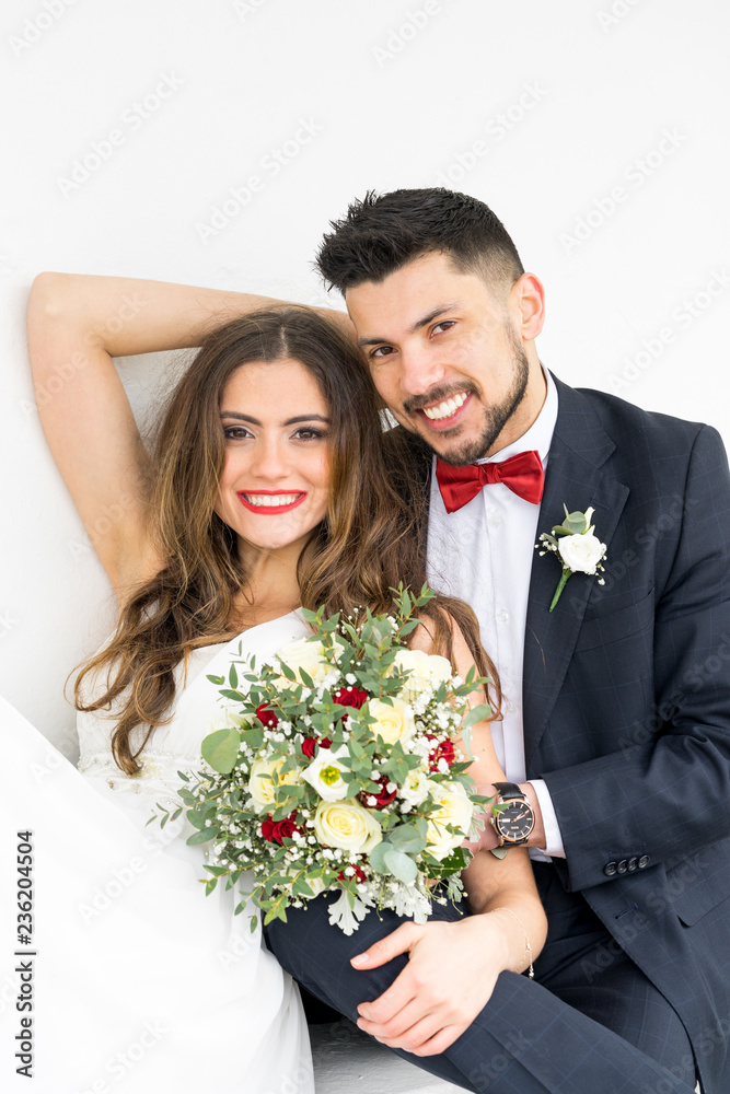 young couple bride groom getting married wedding posed photos at seaside sea beach hairpiece flowers bouquet church
