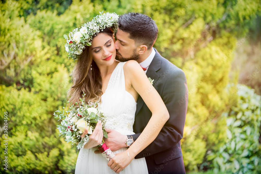 young couple bride groom getting married wedding posed photos at seaside sea beach hairpiece flowers bouquet church