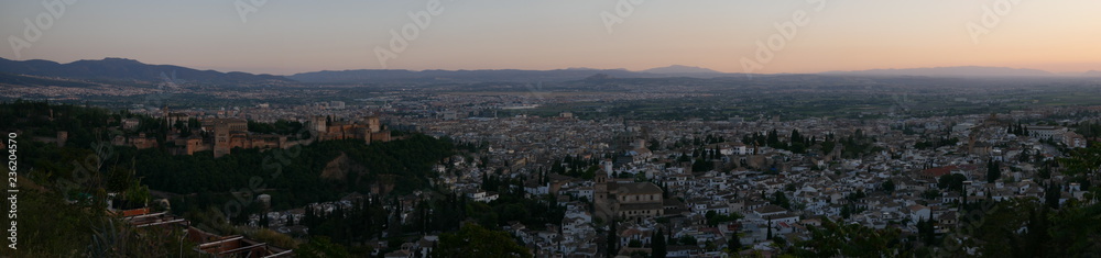Panorama of a beautiful orange sunset over the city of Granada, Spain