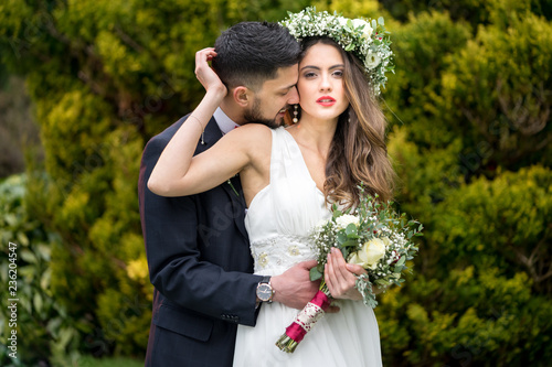 young couple bride groom getting married wedding posed photos at seaside sea beach hairpiece flowers bouquet church