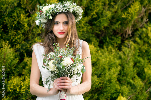 young bride getting married wedding posed photos at seaside sea garden beach hairpiece flowers bouquet 
