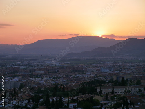 Panorama of a beautiful orange sunset over the city of Granada, Spain