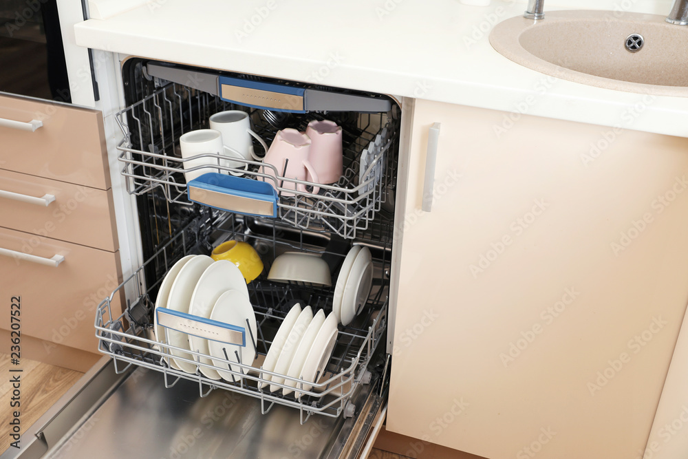 Open dishwasher with clean tableware in kitchen Open dishwasher with clean tableware in kitchen