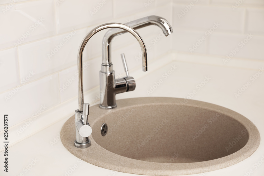 Empty kitchen sink with faucets. Idea for interior design Empty kitchen sink with faucets. Idea for interior design