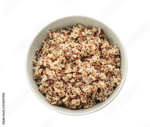 Cooked delicious quinoa in bowl isolated on white, top view