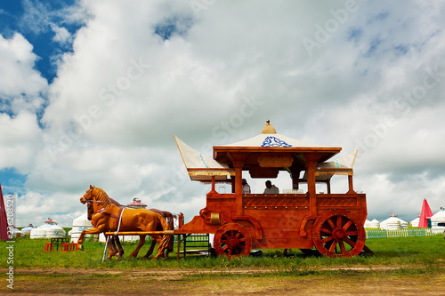 The red carriage on the green grassland. photo