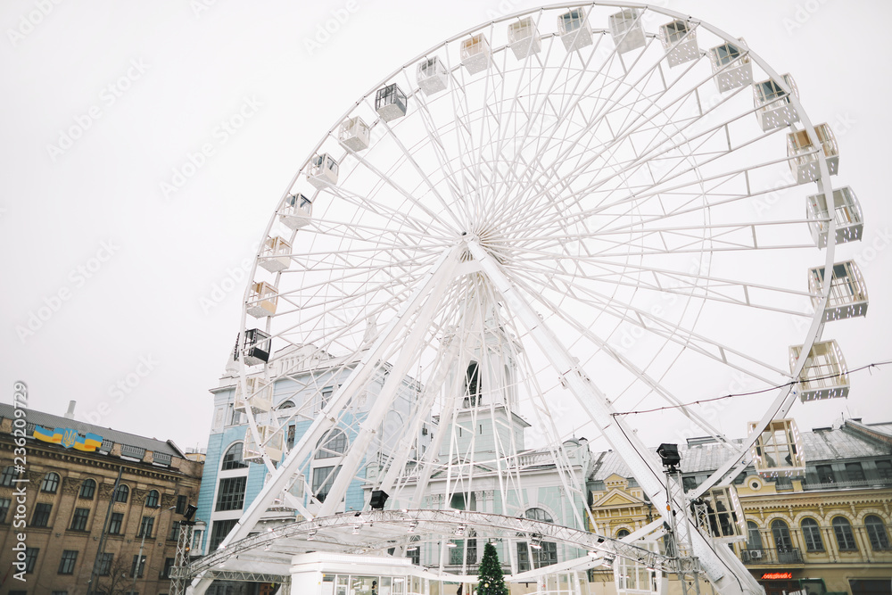 Ferris Wheel at Kontraktova Square in Kiev, Ukraine. November 23, 2018: The Ferris wheel in  Kyiv on the Kontraktova Square on Podil