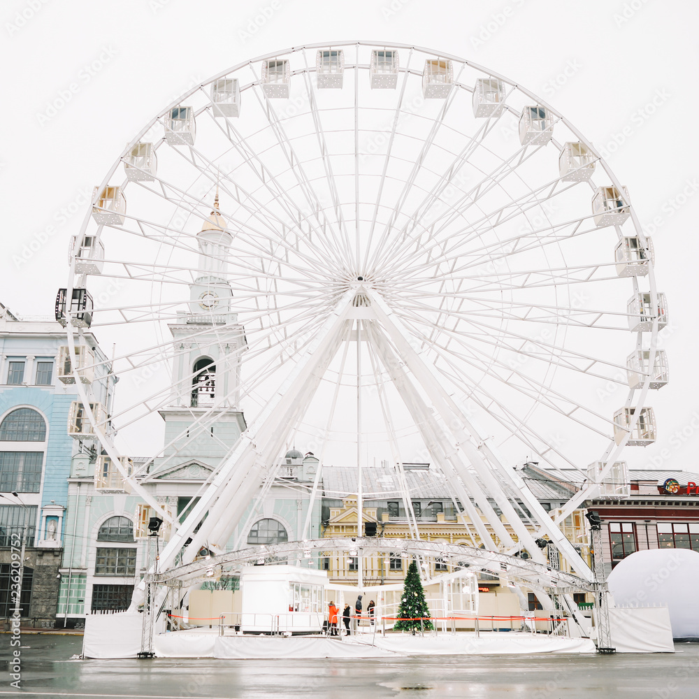 Ferris Wheel at Kontraktova Square in Kiev, Ukraine. November 23, 2018: The Ferris wheel in  Kyiv on the Kontraktova Square on Podil