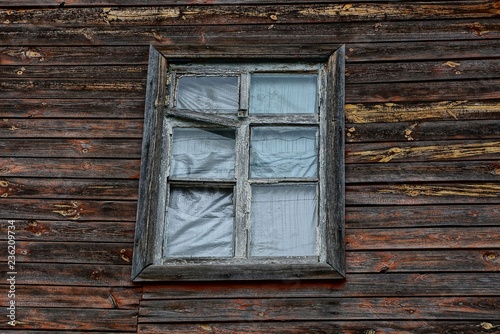 old window on brown wooden plank wall