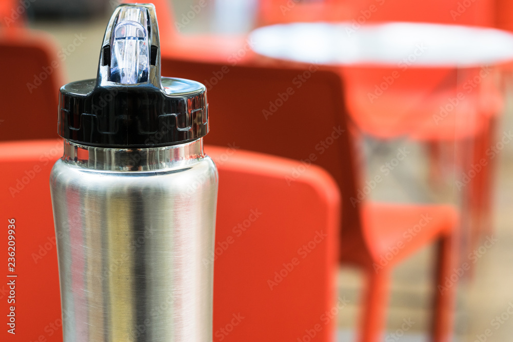 Iron thermos with black lid on defocused background Iron thermos with black lid on defocused background