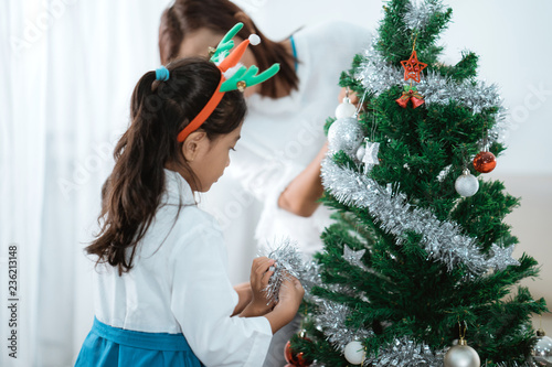 asian family decorate christmas tree photo